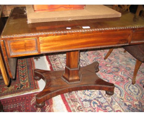 William IV rosewood drop-leaf sofa table with a frieze drawer raised on hexagonal column and platform base with bun feet