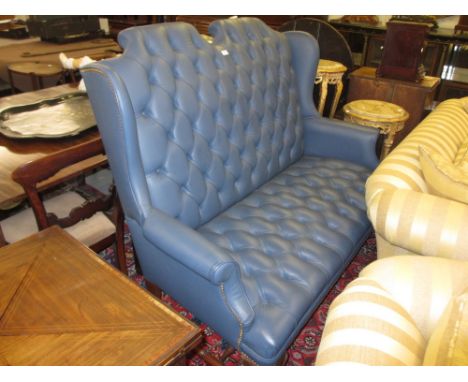 1920's Queen Anne style wing back and blue button leather upholstered two seat sofa on shell carved cabriole pad supports wit