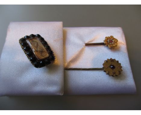 Small mourning brooch set with garnets and woven hair together with two gold ruby and split pearl set stick pins