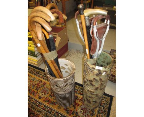 Two pottery stick stands containing a quantity of walking canes, walking sticks and shooting sticks