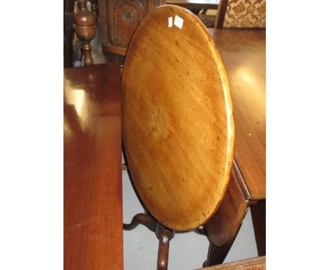 George III mahogany circular pedestal table, the tilt top above a baluster turned column support on tripod base