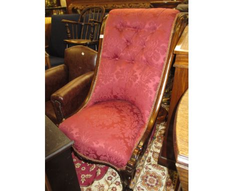19th Century rosewood button upholstered nursing chair having red damask upholstery raised on carved cabriole front supports 
