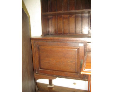 Late 19th or early 20th Century oak dresser with a boarded shelf back incorporating a leaded glass door above two drawers and