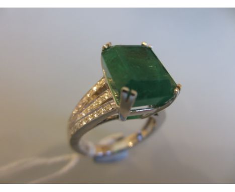 18ct White gold emerald cut emerald ring, approximately 7.06ct with diamond set shoulders