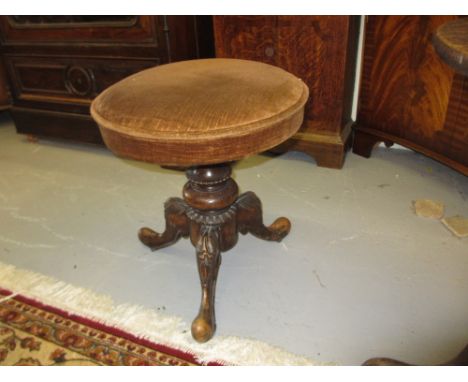 Victorian carved walnut piano stool with revolving seat on tripod base