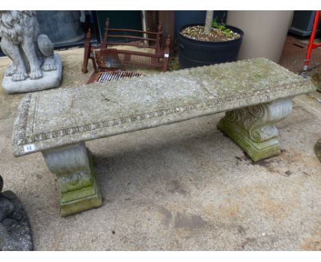 A PEDESTAL GARDEN BENCH.
