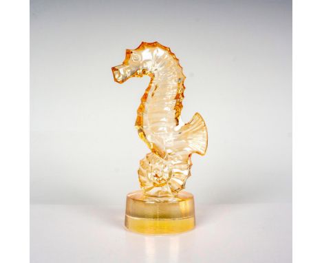 A gold luster crystal seahorse attached to a round base. Lalique France etched backstamp. Dimensions: 1.5"L x 1.75"W x 2"HCou