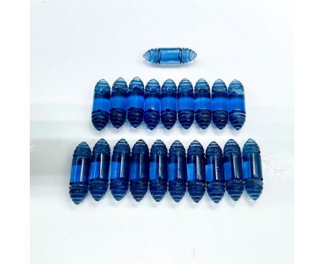 Loose Renaissance bracelet beads consisting of twenty clear navy blue cylinders with segmented cone ends designed by Rene Lal