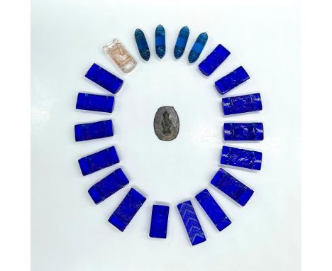 An interesting collection of twenty cast glass beads and one metal impression stamp. Impression stamp is made from a pliable 