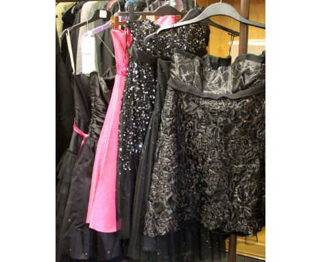 A collection of late 20th century dresses all unworn with original labels, a boned top full skirt with gathered layers, lined