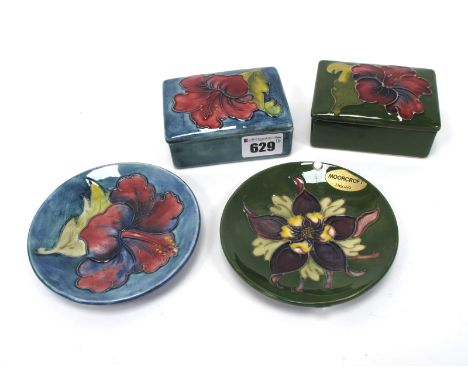 A Moorcroft Pottery Trinket Box and Cover, of rectangular form, painted in the 'Hibiscus' pattern against a dark blue ground,