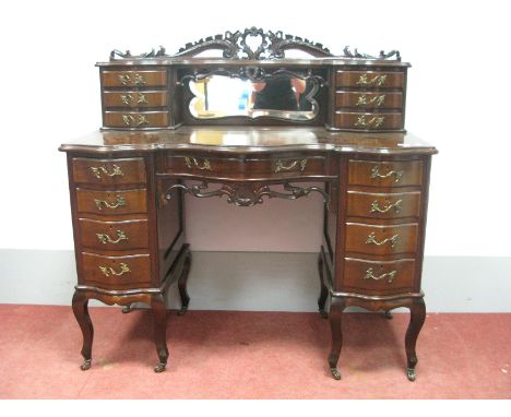 An Early XX Century Mahogany Serpentine Shaped Ladies Dressing Table, the upper section with pierced and carved top, central 