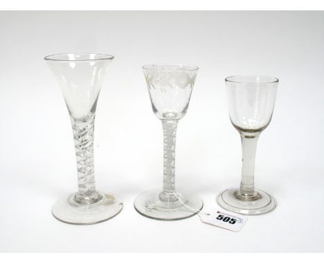 An XVIII Century Wine Glass, the tapered bowl etched with flowers and raised on a white enamel twist stem and circular foot, 