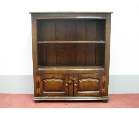 A Titchmarsh & Goodwin Style Oak Bookcase, with single shelf and fielded panels, 97cm high, 84cm wide.