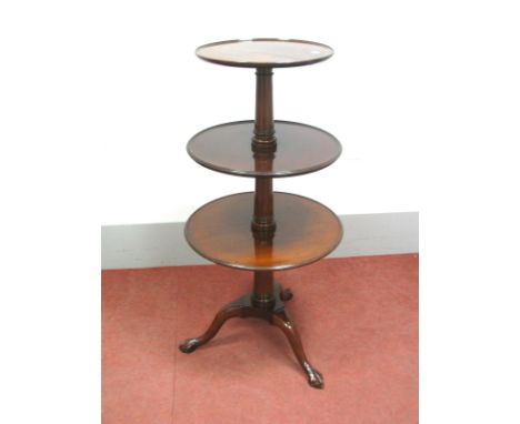 A George III Dumb Waiter, of three tier form, turned gun barrel stem, dished edge trays, tripod base raised on claw and ball 