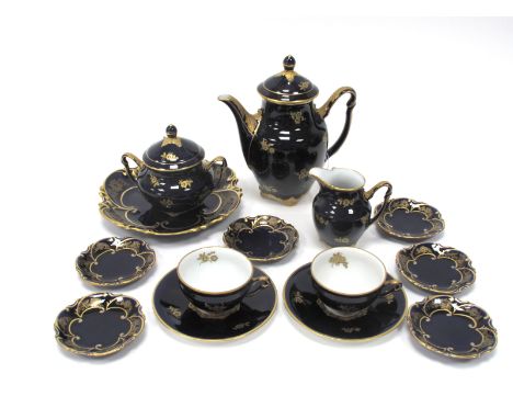 A J.L. Menau Henneberg Porcelain Part Coffee Service, in the 'Konigin Louise' pattern, of gilt floral sprigs on a dark blue g