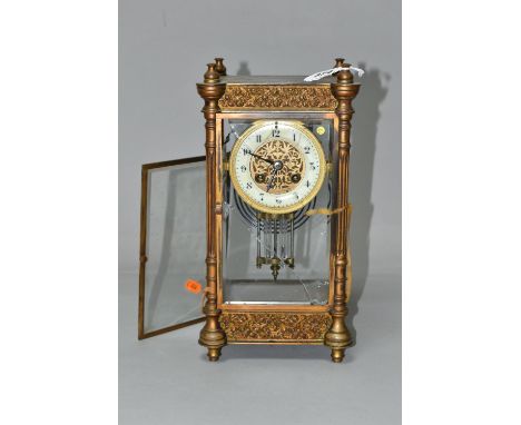 A LATE 19TH CENTURY GILT METAL MANTEL AND FOUR GLASS CLOCK, four columns, pierced foliate panels to the pediment and base, en