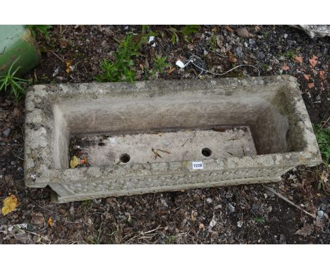 A RECTANGULAR COMPOSITE GARDEN PLANTER, with scrolled ends and detail, length 92cm x depth 34cm x height 26cm (condition - we