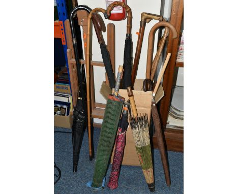 A BOX AND LOOSE WALKING STICKS, UMBRELLAS AND ARTIST'S EASEL, to include an artist's wooden folding table easel, six walking 