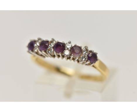 A 18CT GOLD DIAMOND AND AMETHYST RING, five circular cut amethyst stones interspaced with round brilliant cut diamonds (eight
