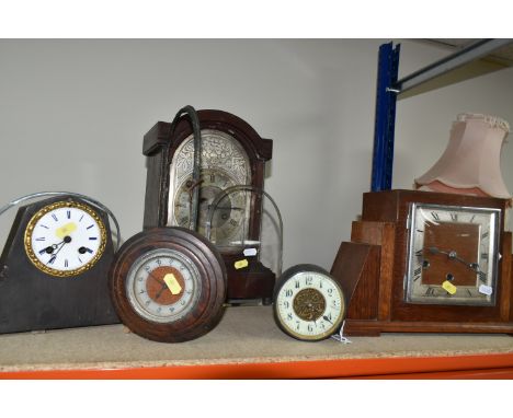 TWO CLOCKS TOGETHER WITH CLOCK PARTS, comprising an Art Deco circular wooden clock (missing base), a metal cased clock moveme