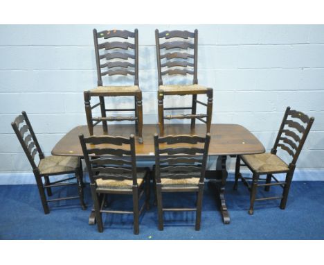 A DARK ERCOL DINING TABLE, length 183cm x depth 80cm x height 73cm, along with a set of six rush seated ladderback chairs (co