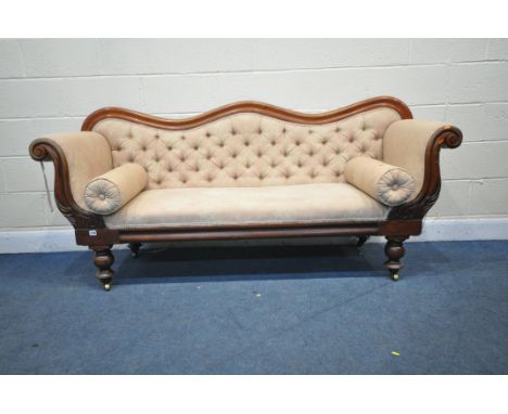 A VICTORIAN WALNUT THREE SEATER SOFA, with a shaped back, scrolled armrests, on turned legs and brass castors, length 200cm x