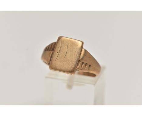 A 9CT GOLD SIGNET RING, yellow gold, rectangular signet with very worn engraved initials, textured shoulders leading onto a p