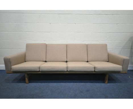 HANS J WEGNER FOR GETAMA, A MID CENTURY DANISH GE236/4 LIGHT OAK FOUR SEATER SOFA, with slatted back and oatmeal upholstery, 