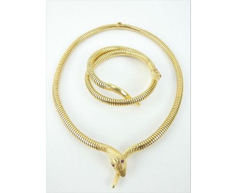 18ct gold coiled serpent sprung necklace and matching bracelet with inset ruby eyes. Both pieces fully hallmarked for 187ct g