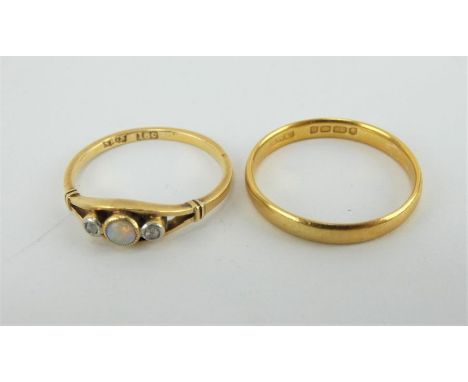 A 22ct gold wedding band,size N (2.4 grams) and an 18ct gold diamond and opal set ring, size L (2 grams)