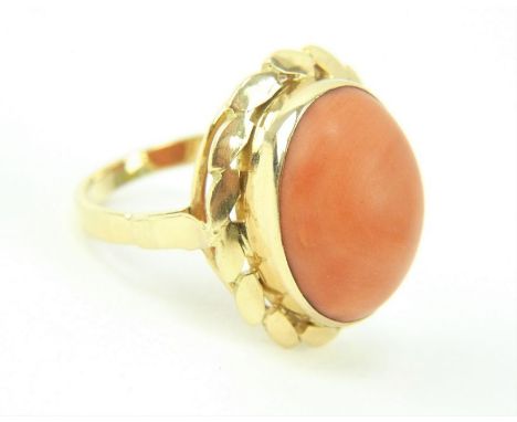 18ct gold ring set with central coral cabochon set within a foliate setting. Size K. Gross weight 4.4 grams.