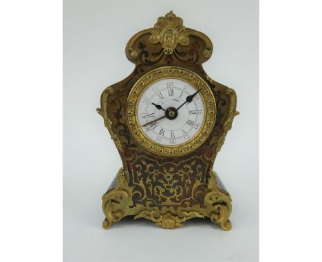 A 19th century French Louis XV style boulle work alarm clock with ornate gilt brass decoration. Enamel dial, brass alarm hand