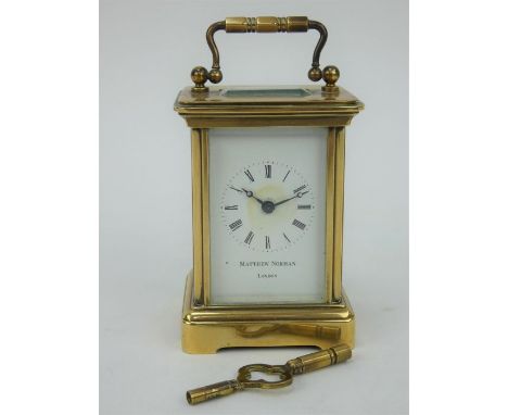 A small Matthew Norman brass cased carriage clock with key.&nbsp; Height 10cm. Winds and runs.&nbsp; Some staining to dial.