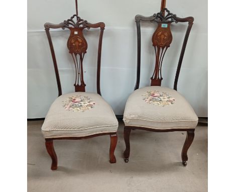 A pair of mahogany inlaid Art Nouveau chairs with tapestry seats and a brass top Indian table with folding base