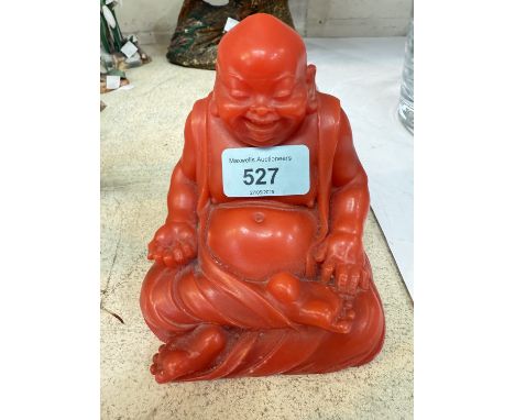A cinnabar coloured figure of a laughing seated Buddha figure, height 13cm.