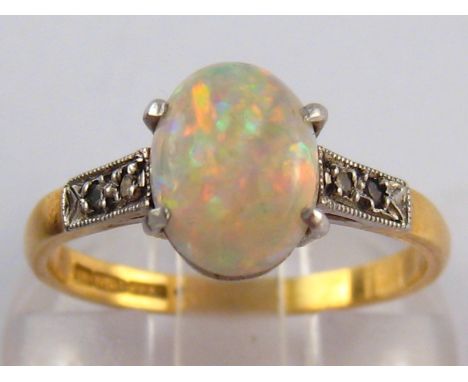 A yellow and white metal (tests 18ct gold and platinum) opal and diamond ring,  the opal of good colour measuring approx 6.5m
