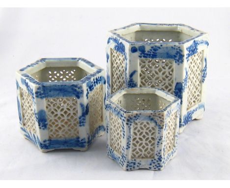 A graduated set of three Chinese ceramic hexagonal jars with pierced side panels, largest 12cm. across. 