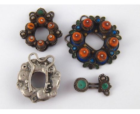 A mixed lot comprising four similar antique white metal (tests silver) pendants one with coral and enamel, the others with va