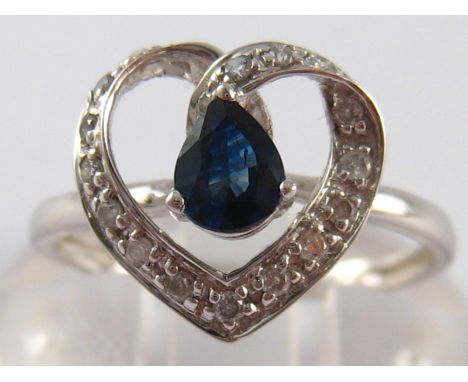 A white metal (tests 18 carat gold) sapphire and diamond heart ring, size K, 1.7 gms.