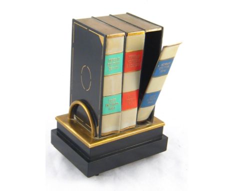 A Soviet tinplate and composition musical cigarette dispenser shaped as a shelf of  books. Ht.15cm. 
