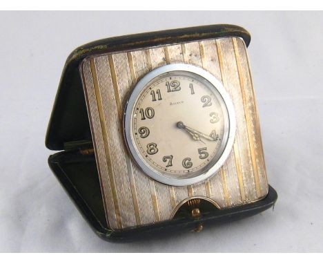 A silver mounted travelling clock, hallmarked Birmingham 1911, approx 9cm wide.
