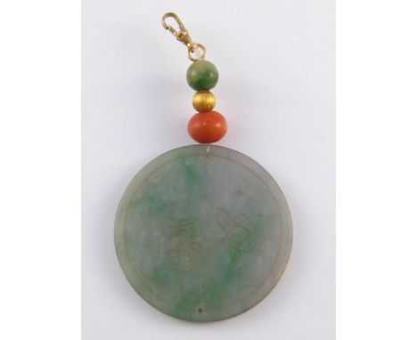 A jade disc pendant, approx 5.2cm diameter, with yellow metal (tests 9ct gold) clasp.