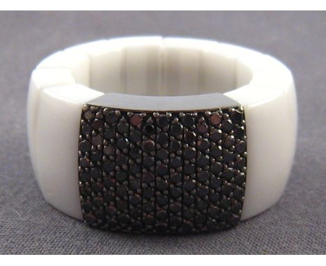 A white ceramic, 18 carat gold and black diamond ring, signed Roberto Demeglio, approx. 12mm wide, ring size M, apparently un