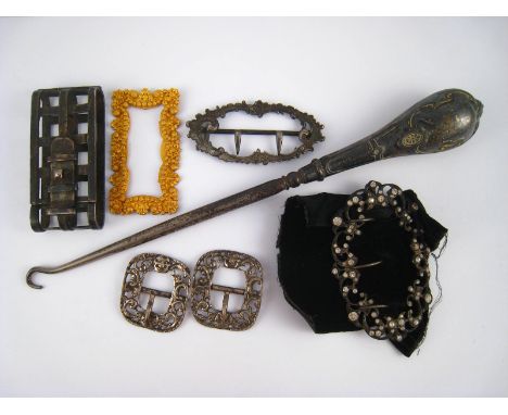 A pair of buckles and four other examples, together with a silver handled button hook.