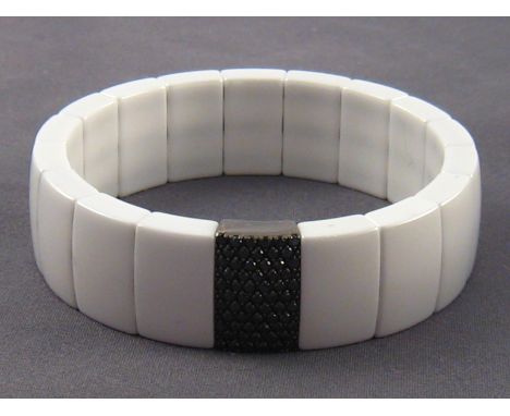 A white ceramic, 18 carat gold and black diamond bracelet, signed Roberto Demeglio, approx. 17mm wide, apparently unused.
