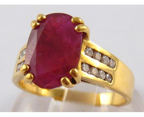 An 18 carat gold composite ruby and diamond ring, ruby approx 11.5 x 8mm, ring size N, 5.3 gms.