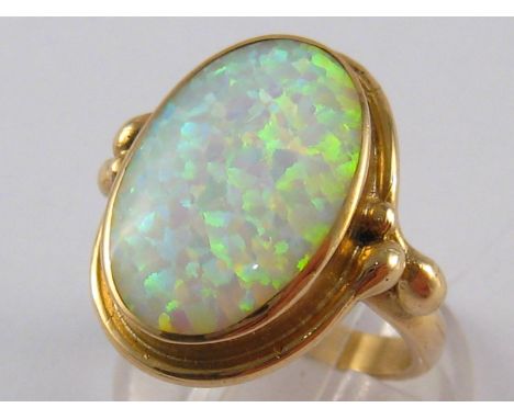 A 9 carat gold opal doublet ring, approx 2cm long, ring size P, 8.2 gms.