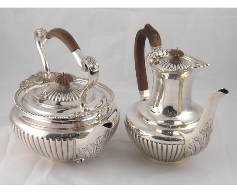 A very large silver tea kettle, circular with ribbed sides and side hinged lid, leaf capped fixed handle and ornamented spout