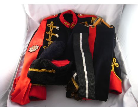 Militaria. A Hussar dress uniform or theatrical costume comprising black trousers with red stripe, black jacket with gold bra